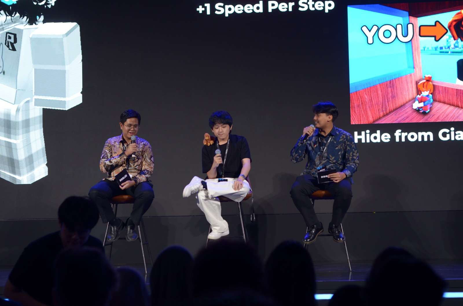 Christopher on a panel with his Roblox games displayed behind him